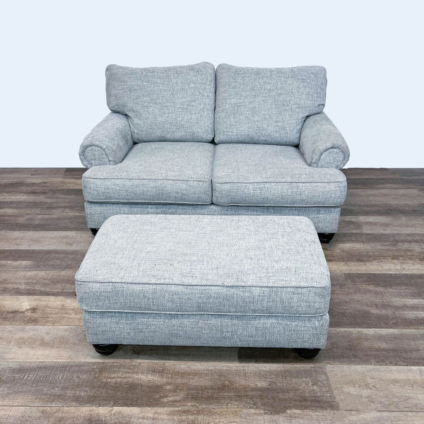 1. Reperch loveseat and rectangular ottoman in matching fabric with dark bun feet, shown on wood floor.  