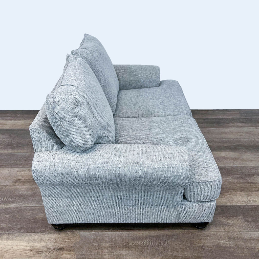 3. Profile view of the Reperch loveseat, featuring plush cushions, fabric upholstery, and rounded arms.