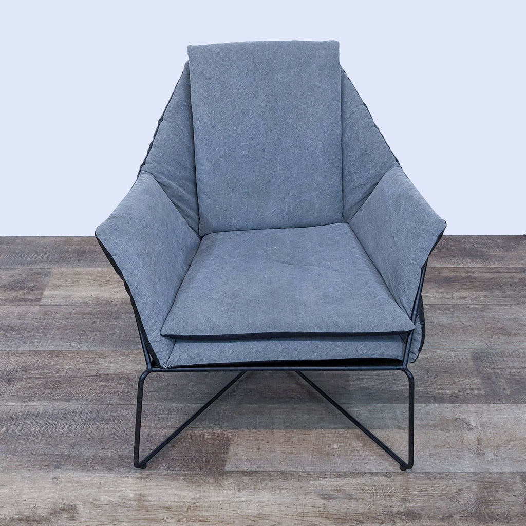 Front view of lounge chair with soft upholstery and sleek metal base, designed for comfort.