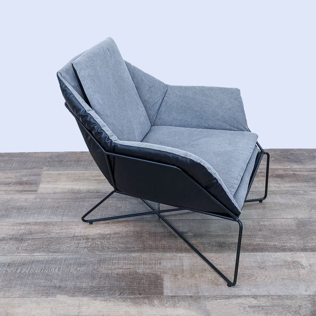 Side view of a Reperch lounge chair with metal frame and cushioned seat, leaning back slightly.