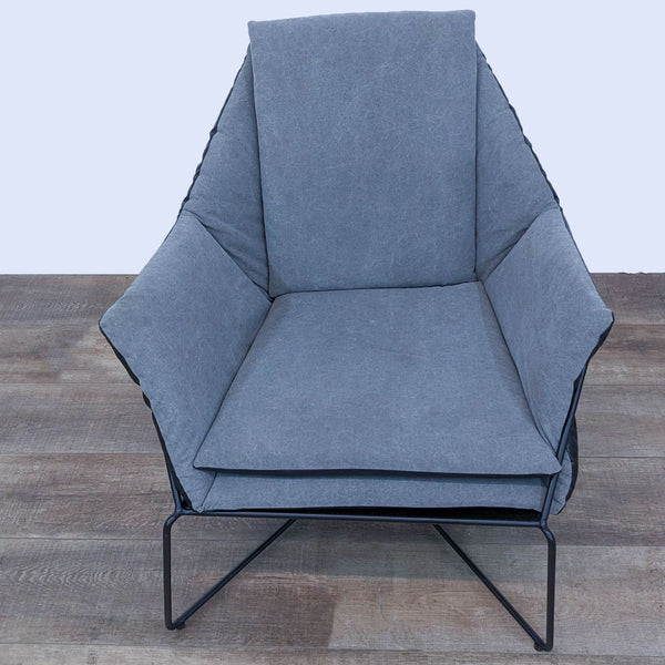 Modern lounge chair with tubular metal frame and soft upholstery, angled for comfort.