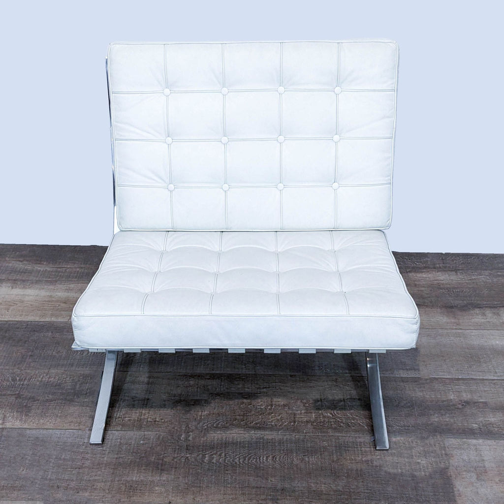 Front view of a white leather lounge chair with tufted squares.