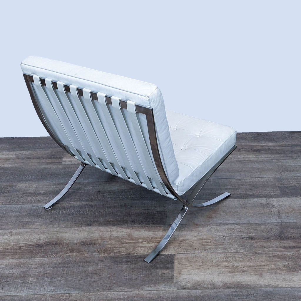 Back view showing leather straps and stainless steel frame of a lounge chair.