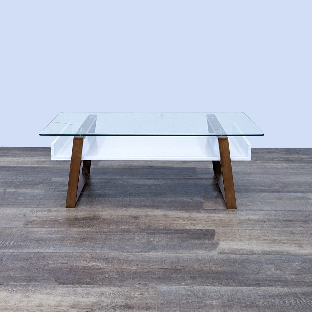 Modern glass-top coffee table with wooden legs and white shelf, by Reperch.