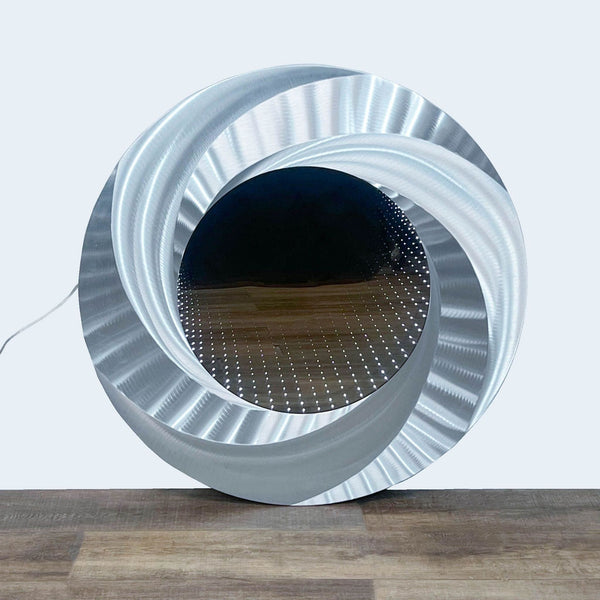 a circular light with a wire mesh on top.