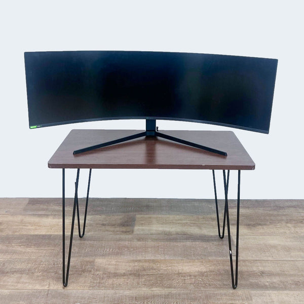 Curved Samsung Odyssey G9 Gaming Monitor placed on a wooden table.