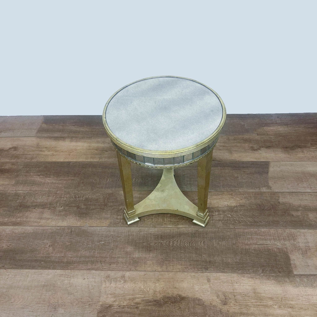 Top view of metallic round table with mirrored surface.