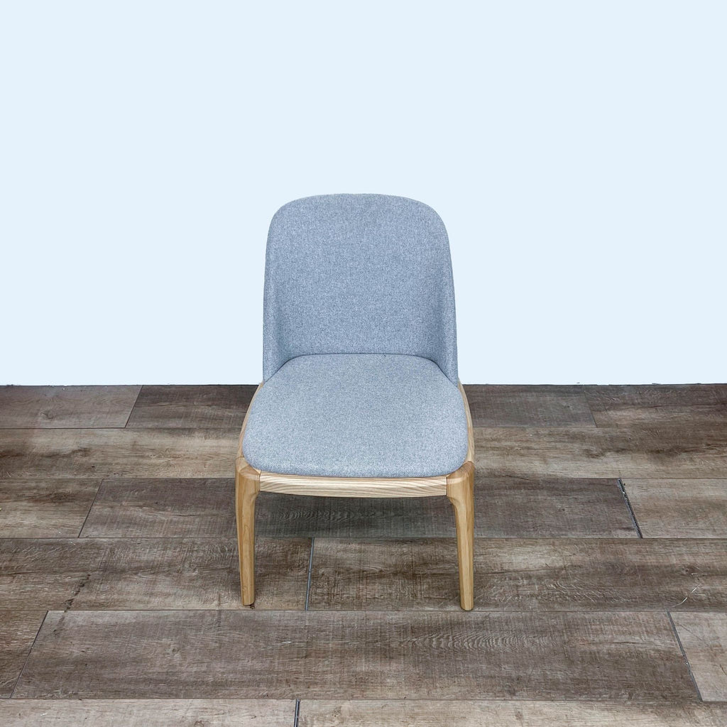 Reperch transitional dining chair with splayed legs and upholstered seat, front view on wood floor.