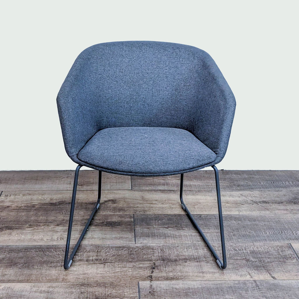 Gray lounge chair with durable upholstery and sleek steel sled base.