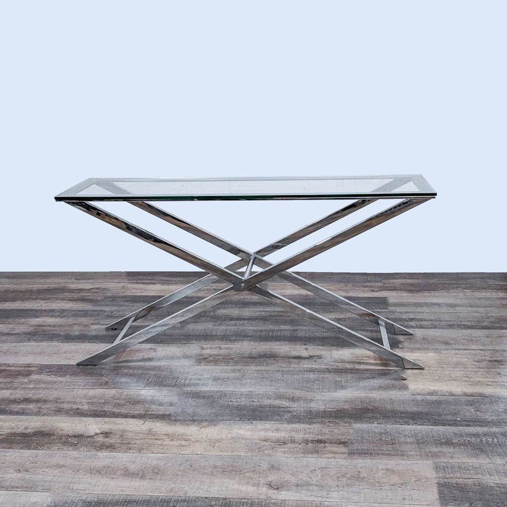 Glass console table by Reperch, featuring sleek metal X-shaped legs.