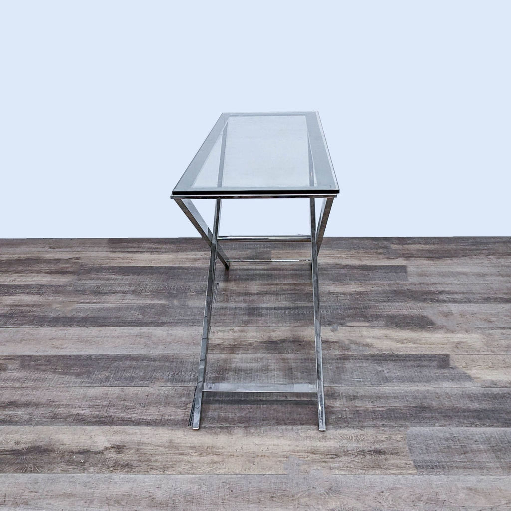 Stylish Reperch console table with metal base and transparent glass surface.