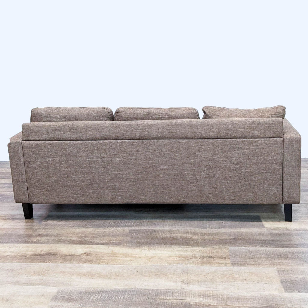 Back view of Reperch 78" sectional sofa with dark finish feet.