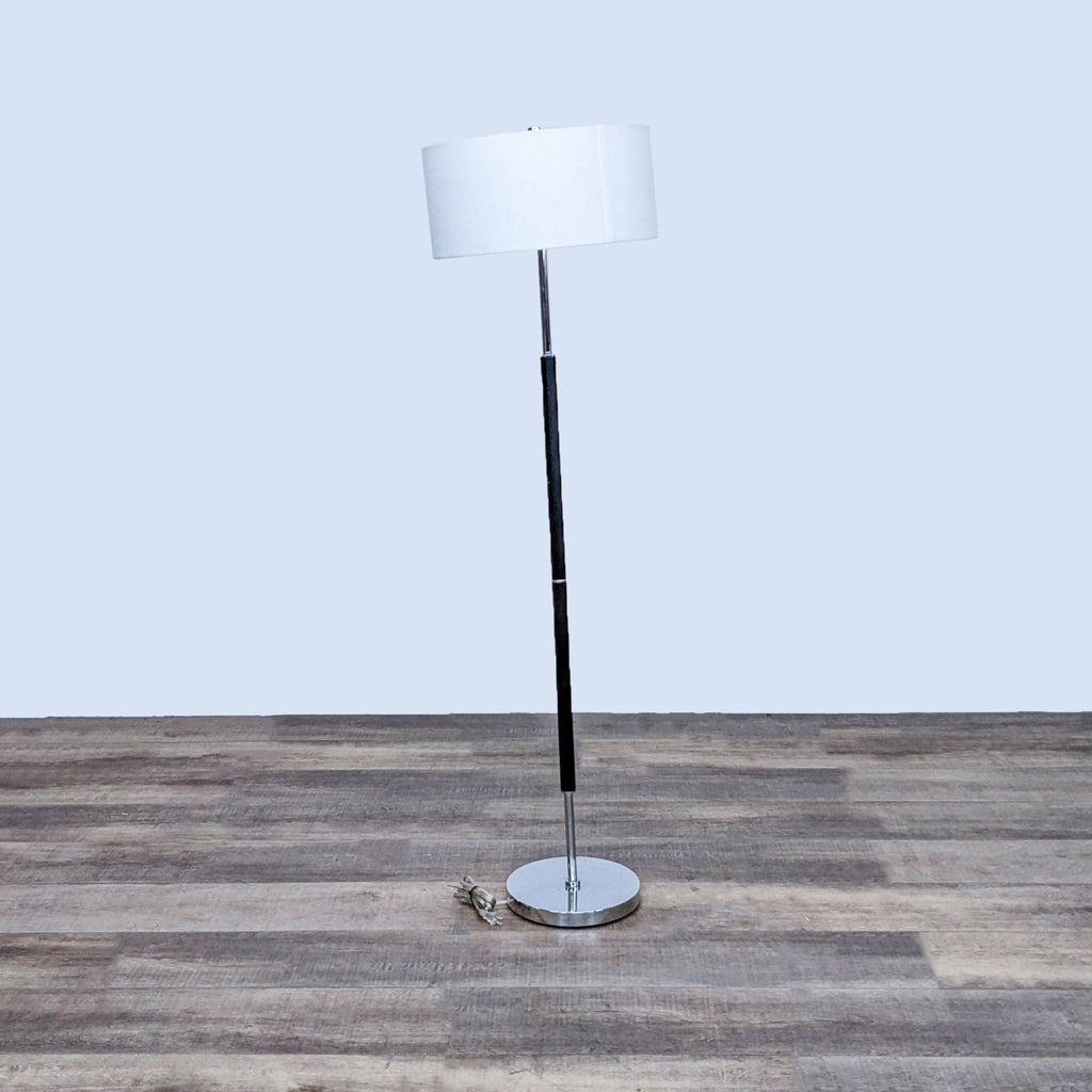 Stylish floor lamp by Reperch, featuring a round base and white lampshade.