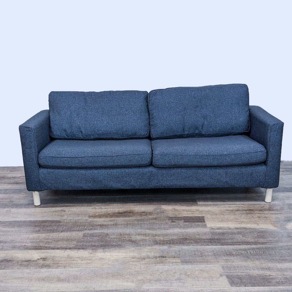 Dark gray 3-seat sofa with narrow arms and light wood legs on wooden floor.