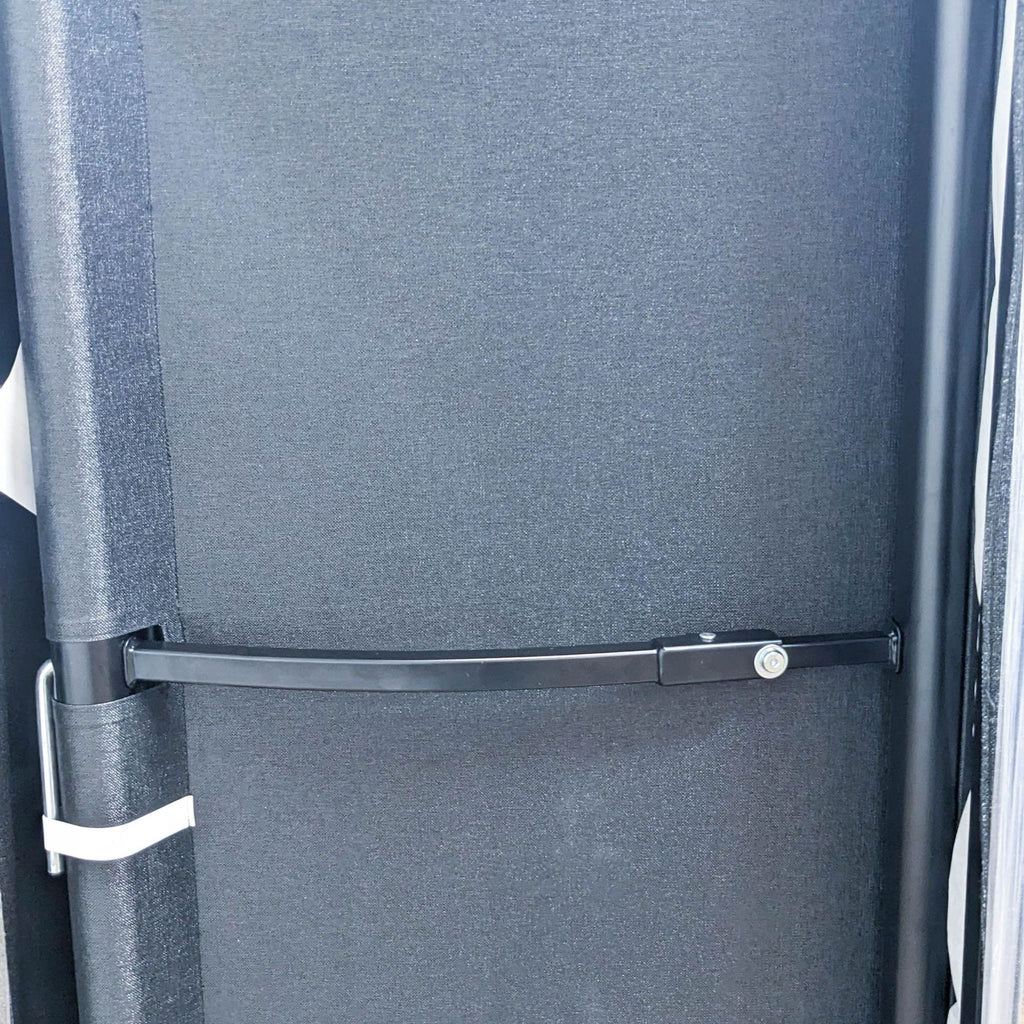 Close-up of sofa's back with fabric cover and supportive structure.