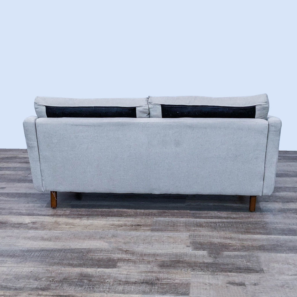 73" beige Reperch sofa, wood legs, accent pillows, narrow-armed design.