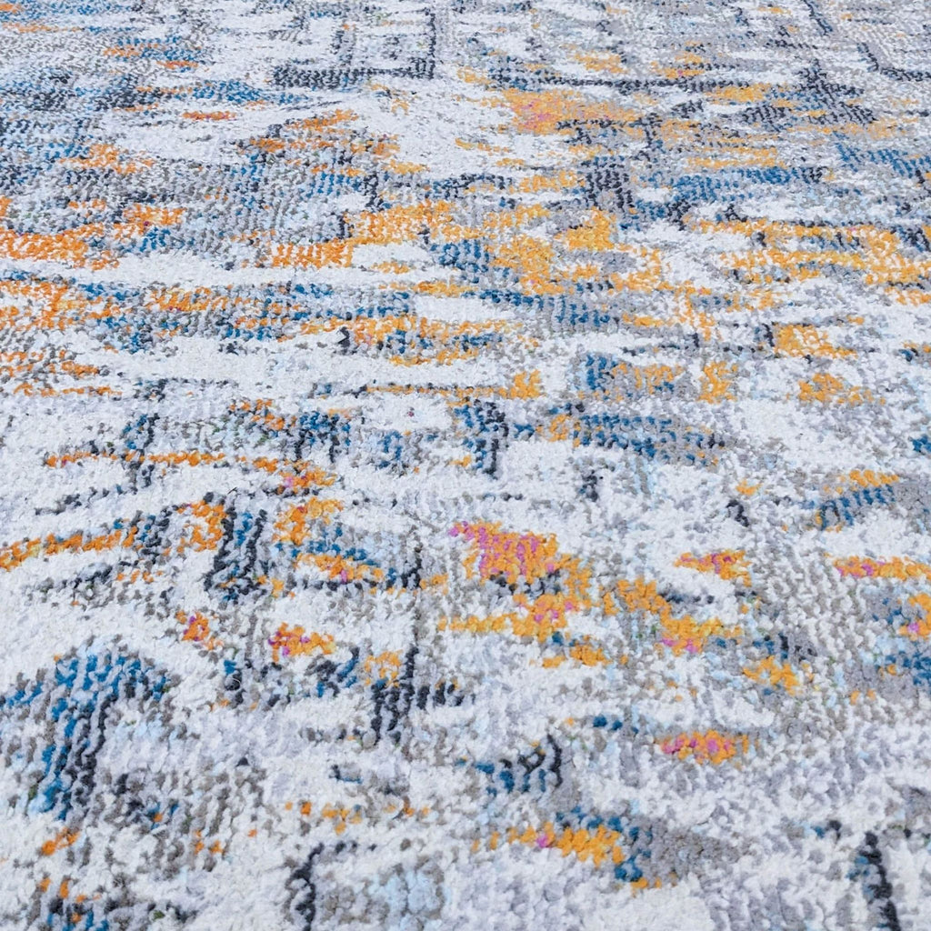 Close-up of rug highlighting detailed medallion and floral vine patterns in mixed colors.