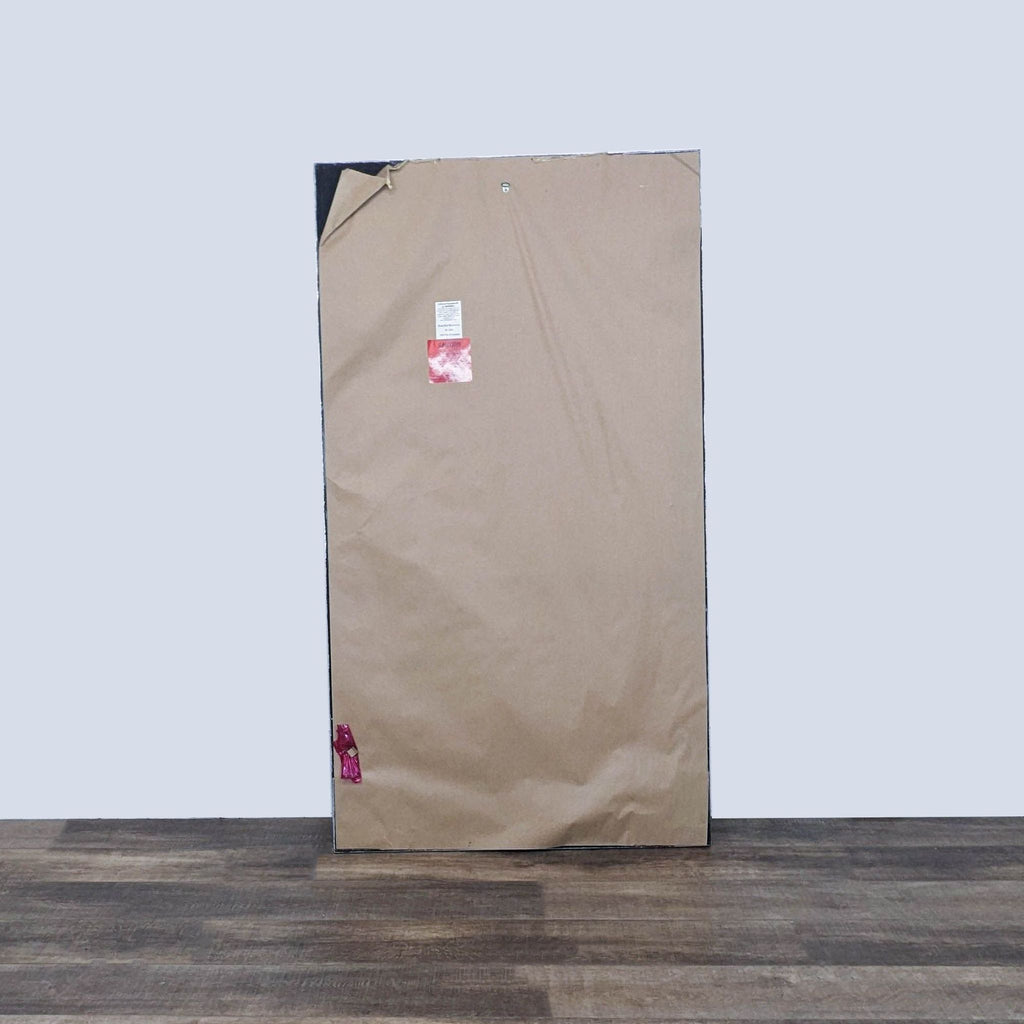 Back view of the full-length Reperch mirror with a protective covering.