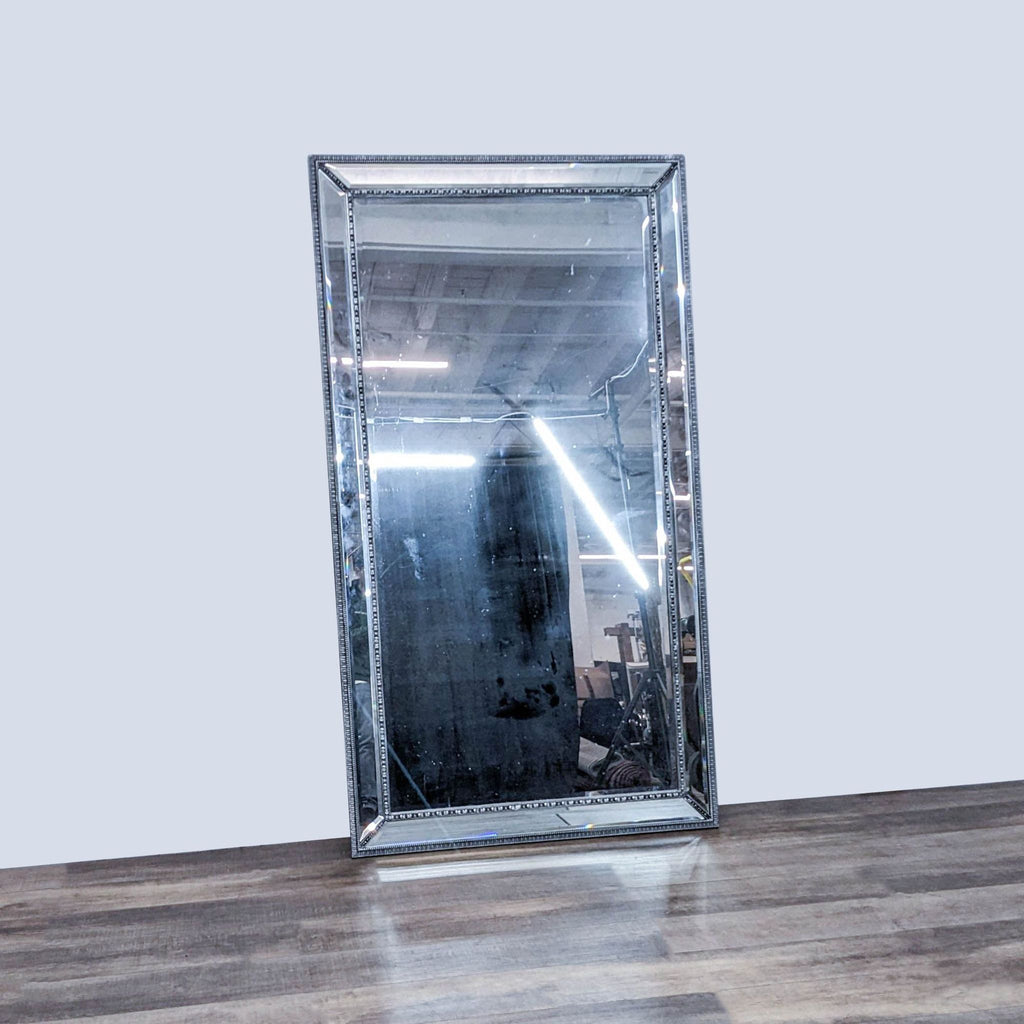 Ornate full-length mirror with beveled silver frame, reflecting an interior setting.