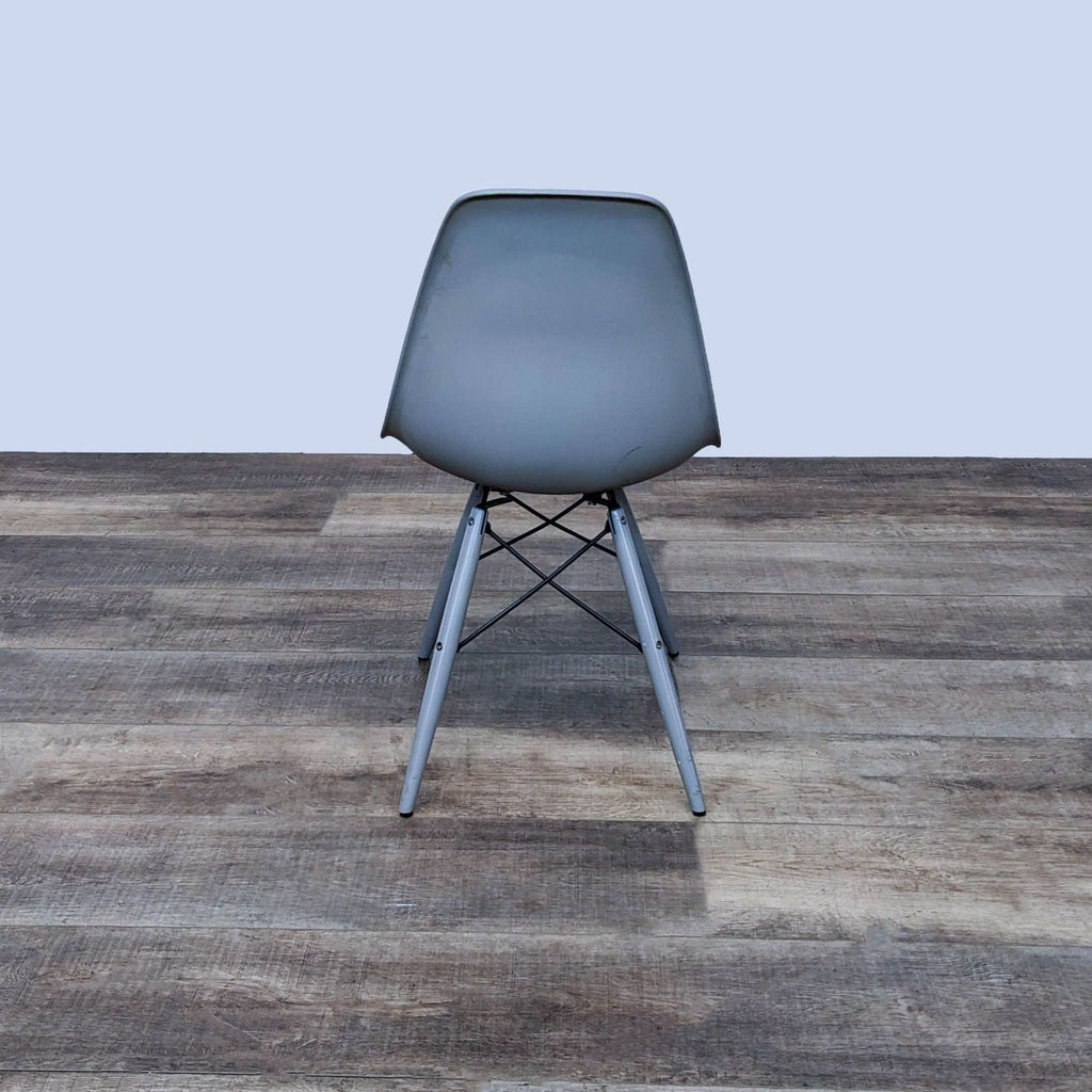 Rear view of a stylish two-toned chair with metal Eiffel base.