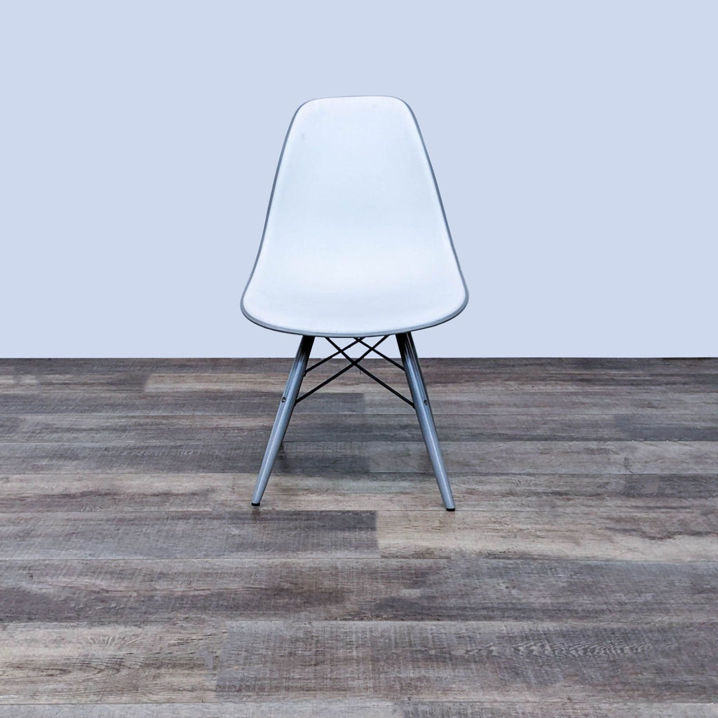 Front view of a two-toned modern dining chair with Eiffel-style base.