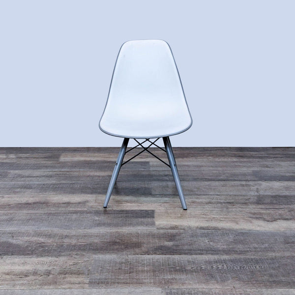 the chair is a modern design that is made of steel and has a white frame.