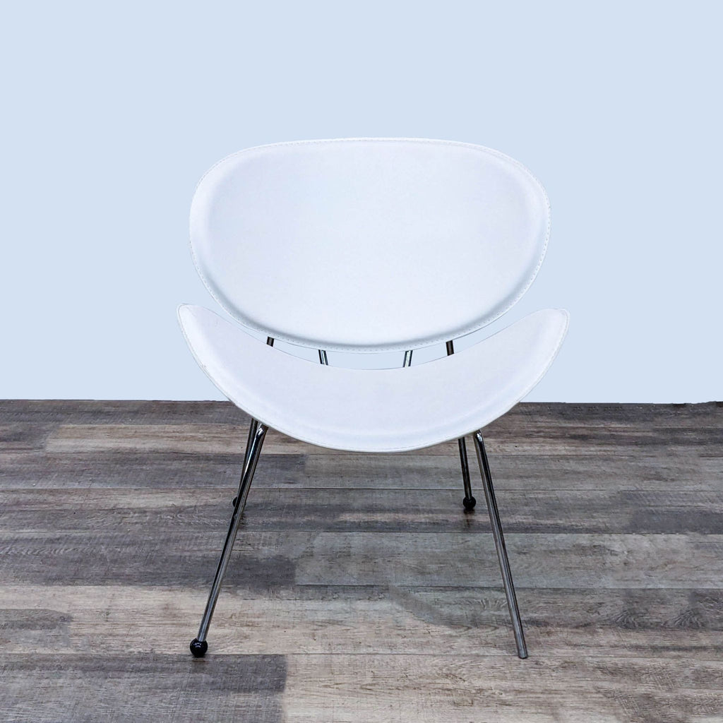 Front view of the Luther lounge chair with curved leatherette seat and chromed legs by Strick & Bolton.