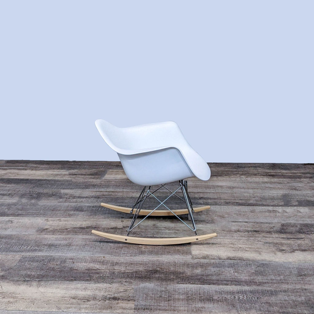 Side view of a modern white rocker chair with chrome steel base.