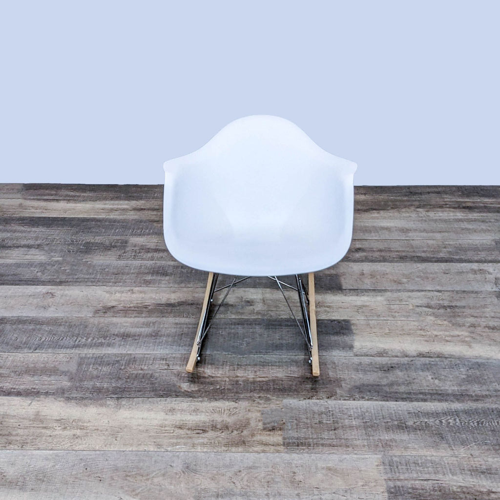 Front view of Reperch white bucket seat rocker on wooden floor.
