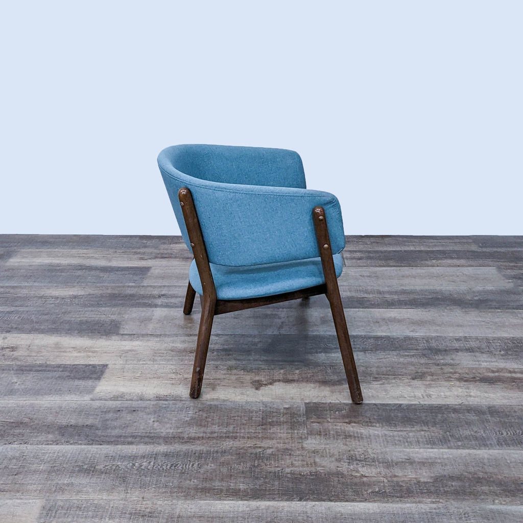 Side view of a blue Chapel lounge chair with retro design.
