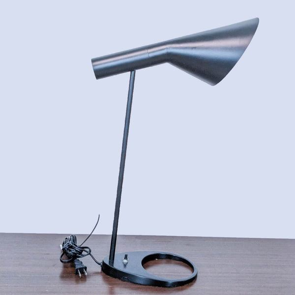 Sleek black desk lamp with a circular base and an adjustable conical shade.