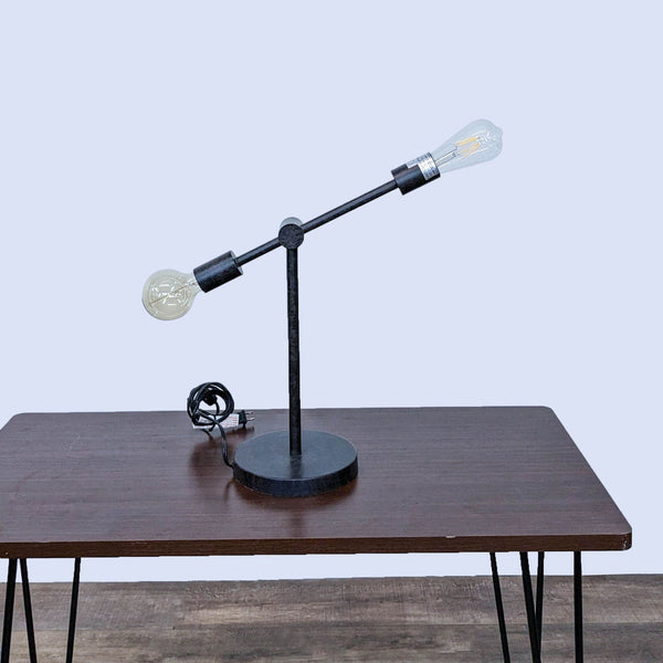 Reperch lamp with dual bulbs on a wooden table, minimalist design.