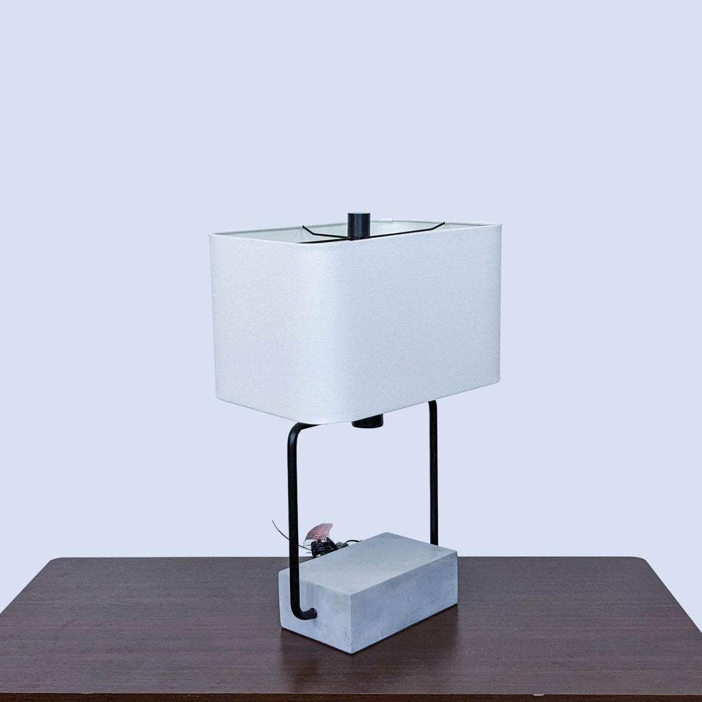 the table lamp is made of a white ceramic block with a white base.