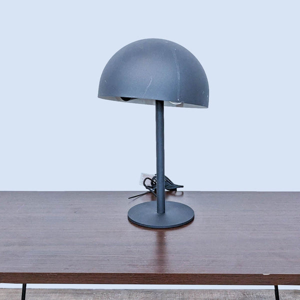 Reperch dome-shaped table lamp on a wooden surface.