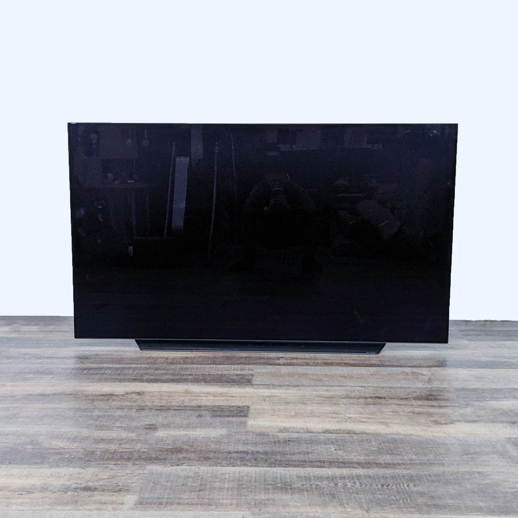 Front view of an LG TV with a dark, blank screen.