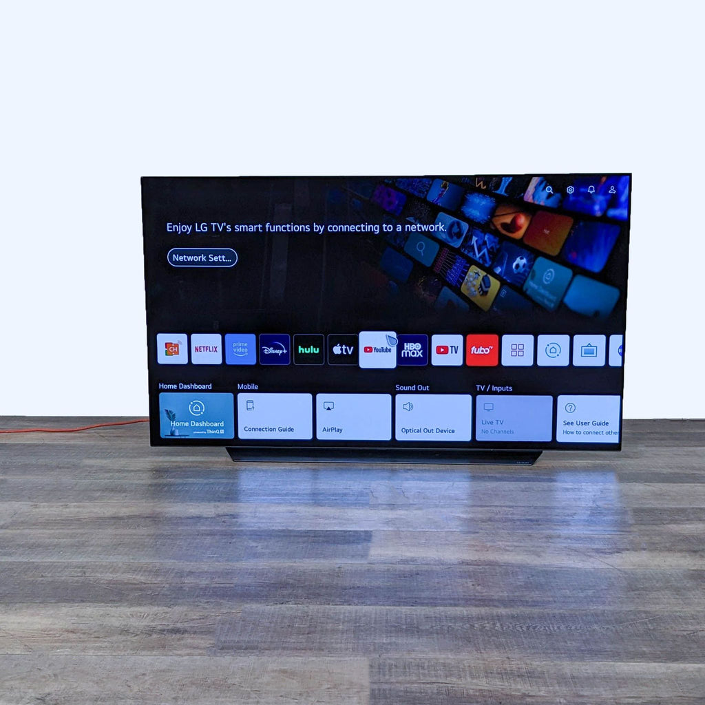 LG TV displaying a smart menu with app icons and network setup.