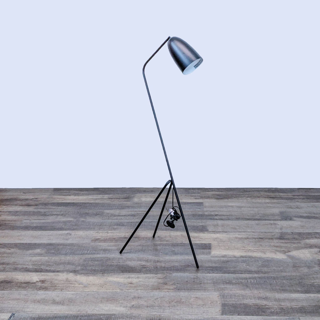 Reperch floor lamp with a sleek, minimalist design on a wooden floor.