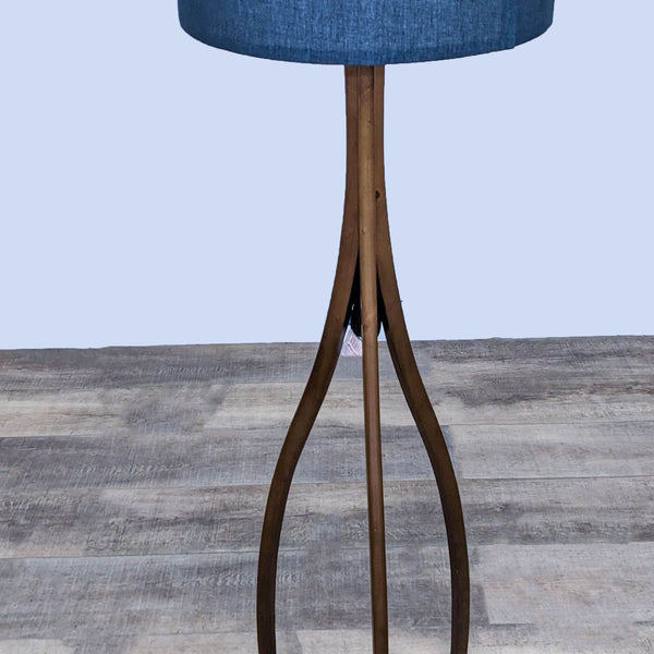 Dark wood tripod floor lamp with a blue fabric shade.
