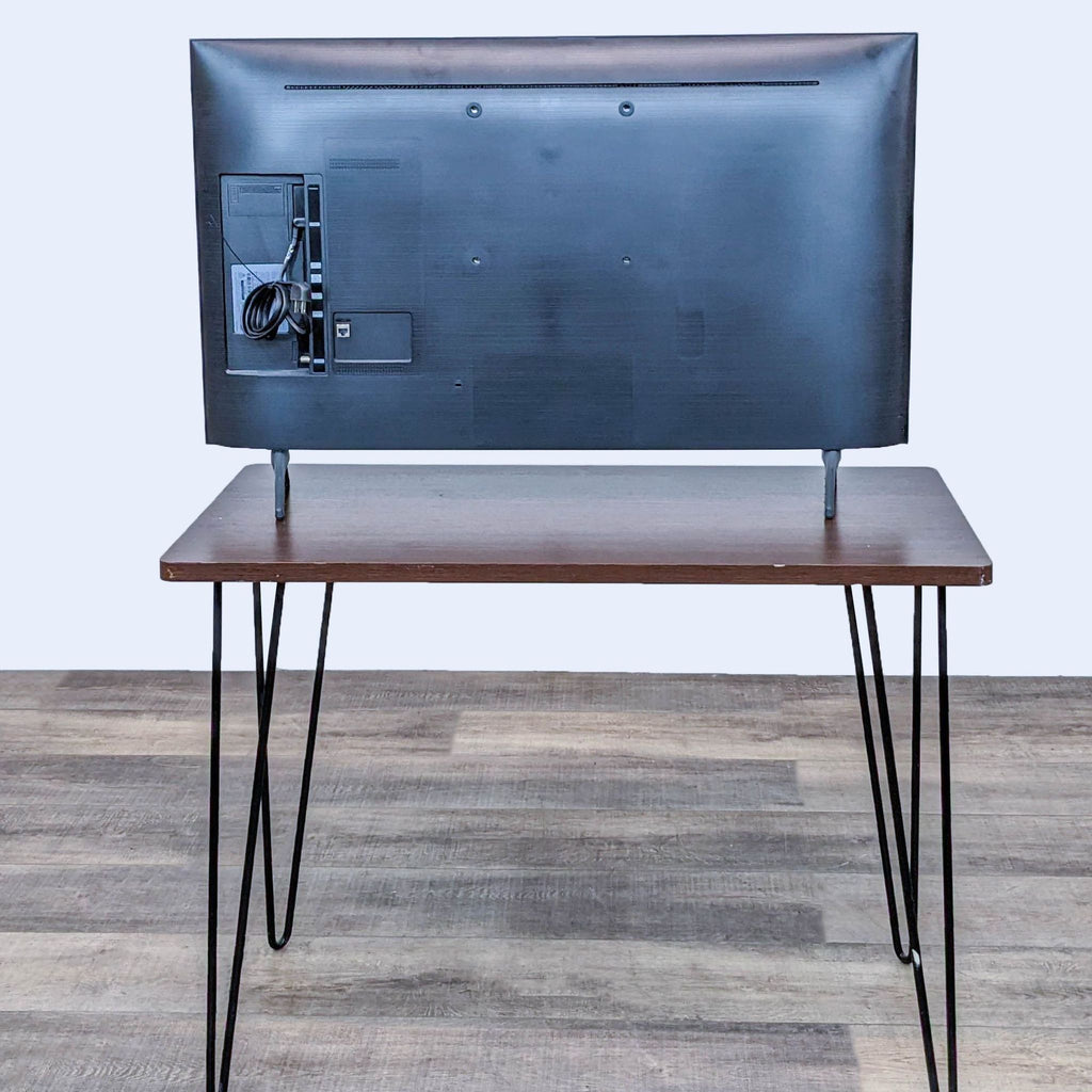 Rear view of a Samsung TV showing ports and cables.