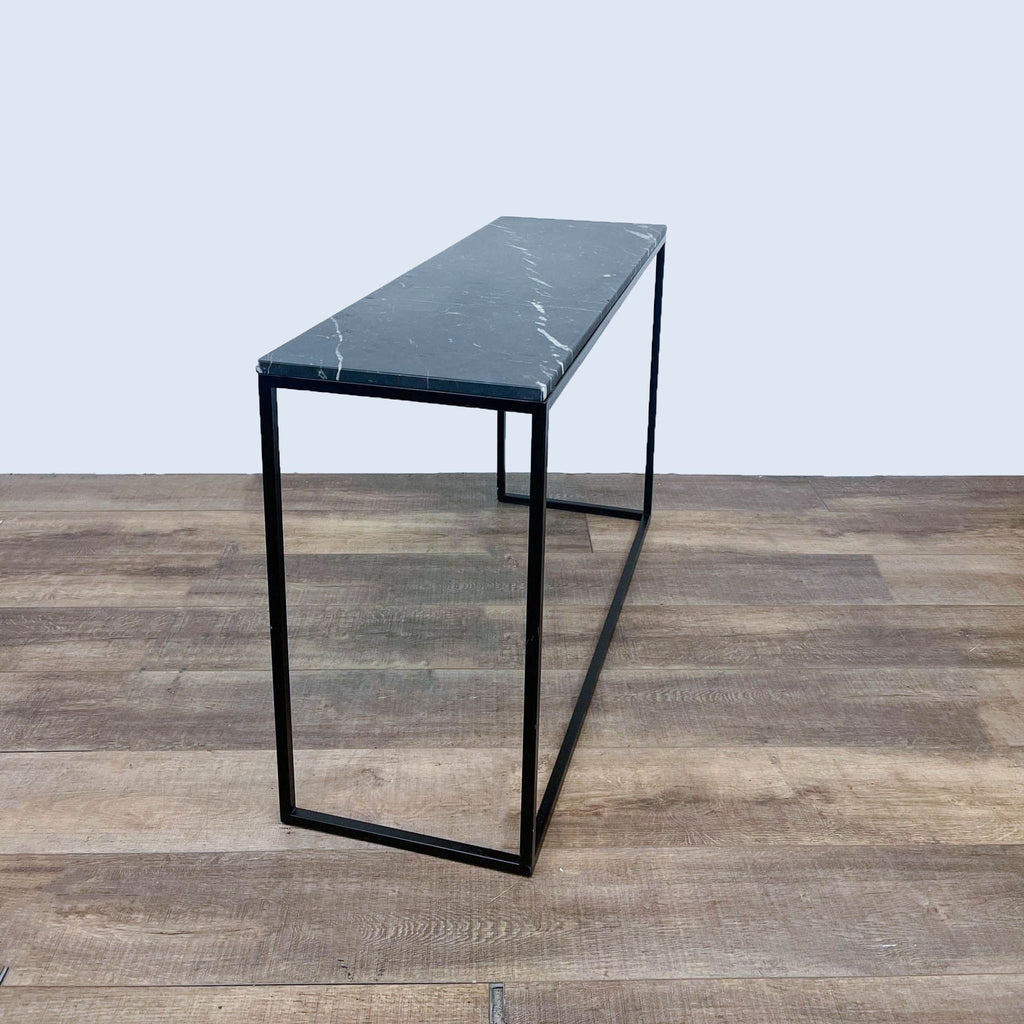Minimalist console table by Reperch featuring a metal frame.