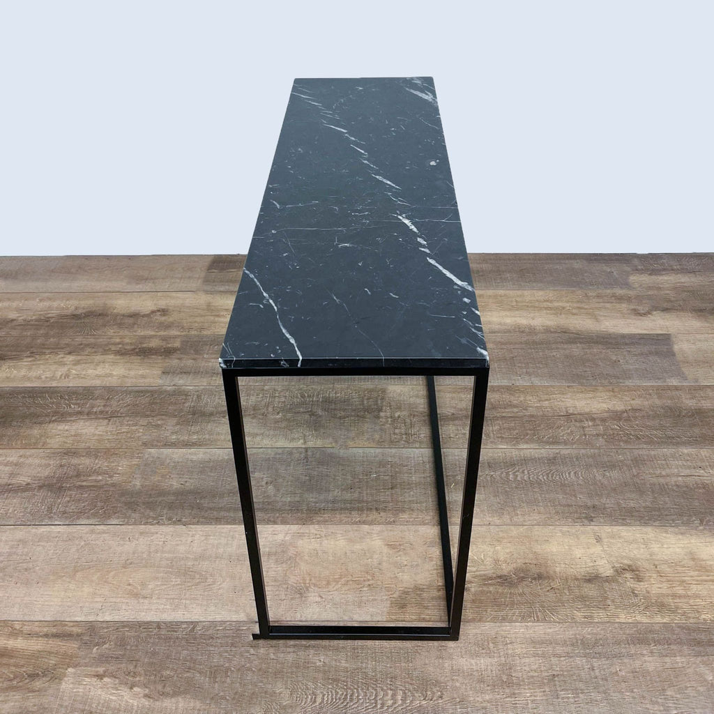 Reperch metal frame table with a rectangular stone surface.