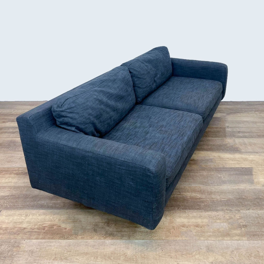 Side view of a Reperch 3-seat sofa with sleek armrests.