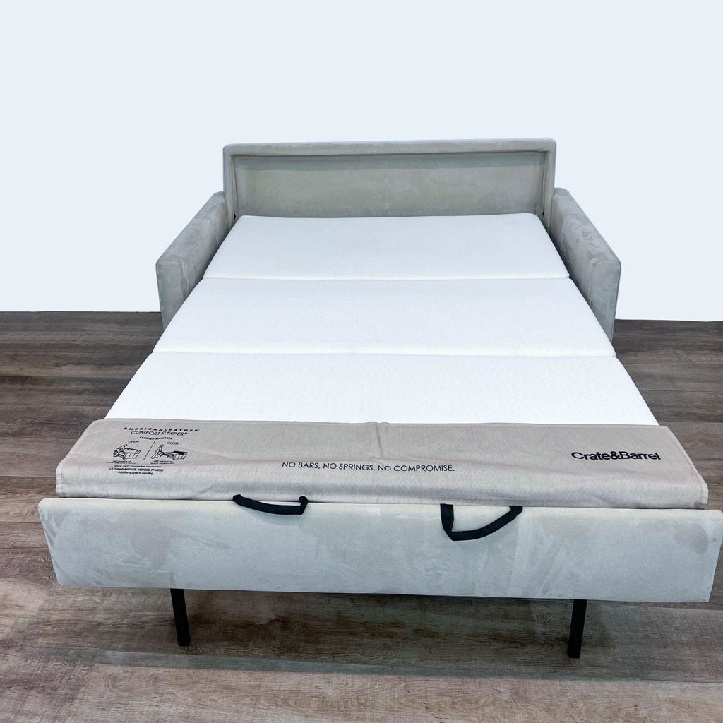 Open sleeper sofa showcasing mattress with no bars or springs.