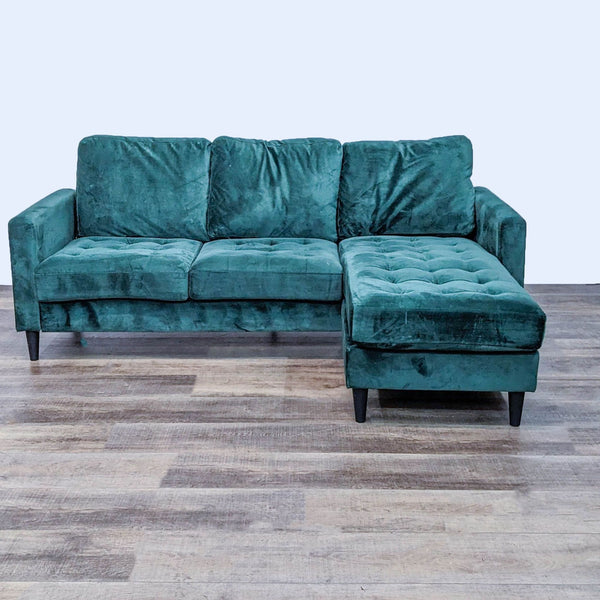 Green tufted sectional with drop-down back and reversible chaise for lounging.