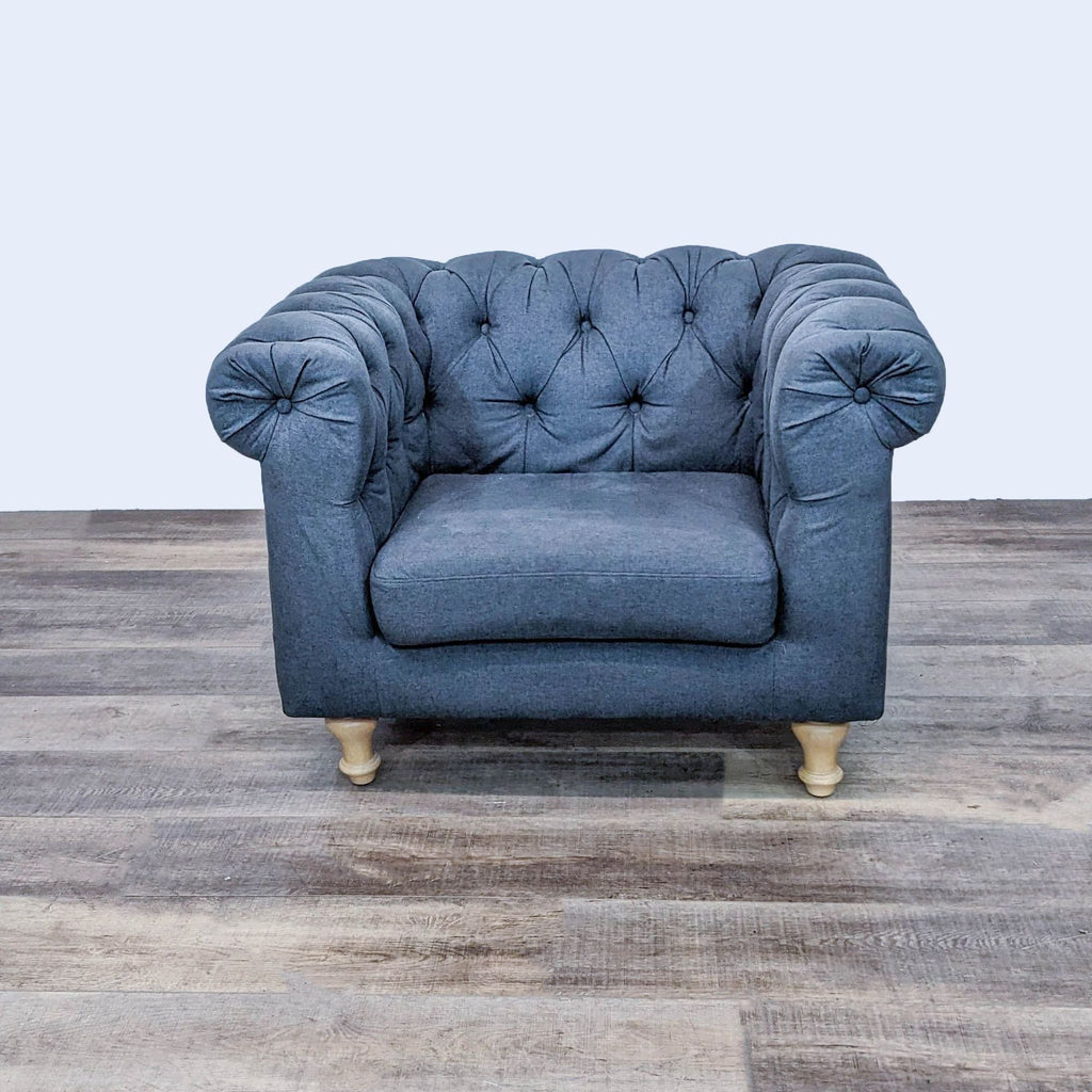 Lounge chair with rolled arms, wood feet, and button-tufted fabric upholstery by World Market.