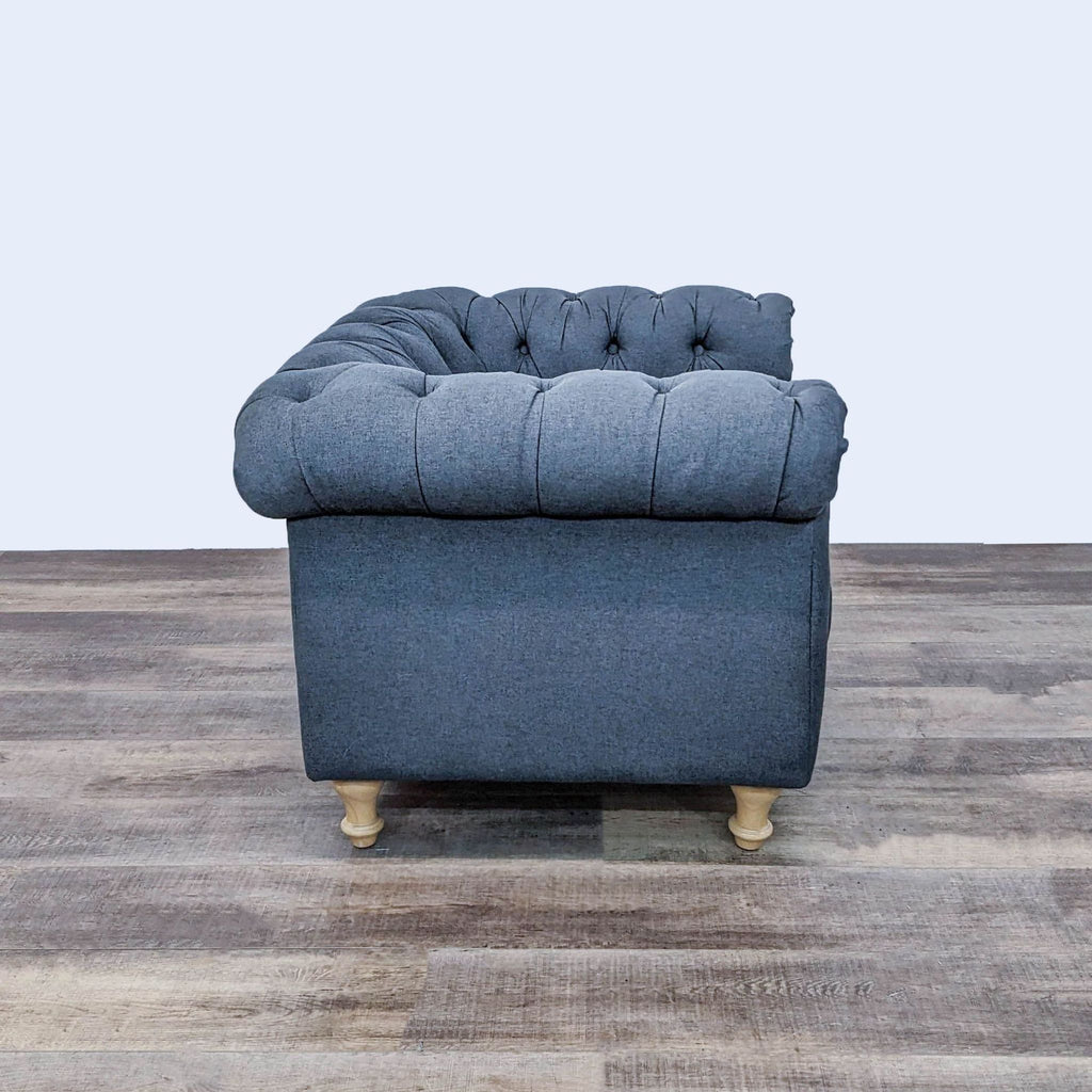 Club chair from World Market with tufted fabric, turned wooden feet, and rolled arms.