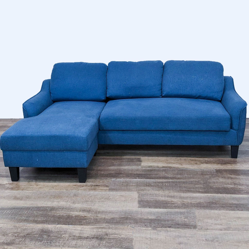 Reperch sectional with chaise, dark wood feet, blue upholstery.