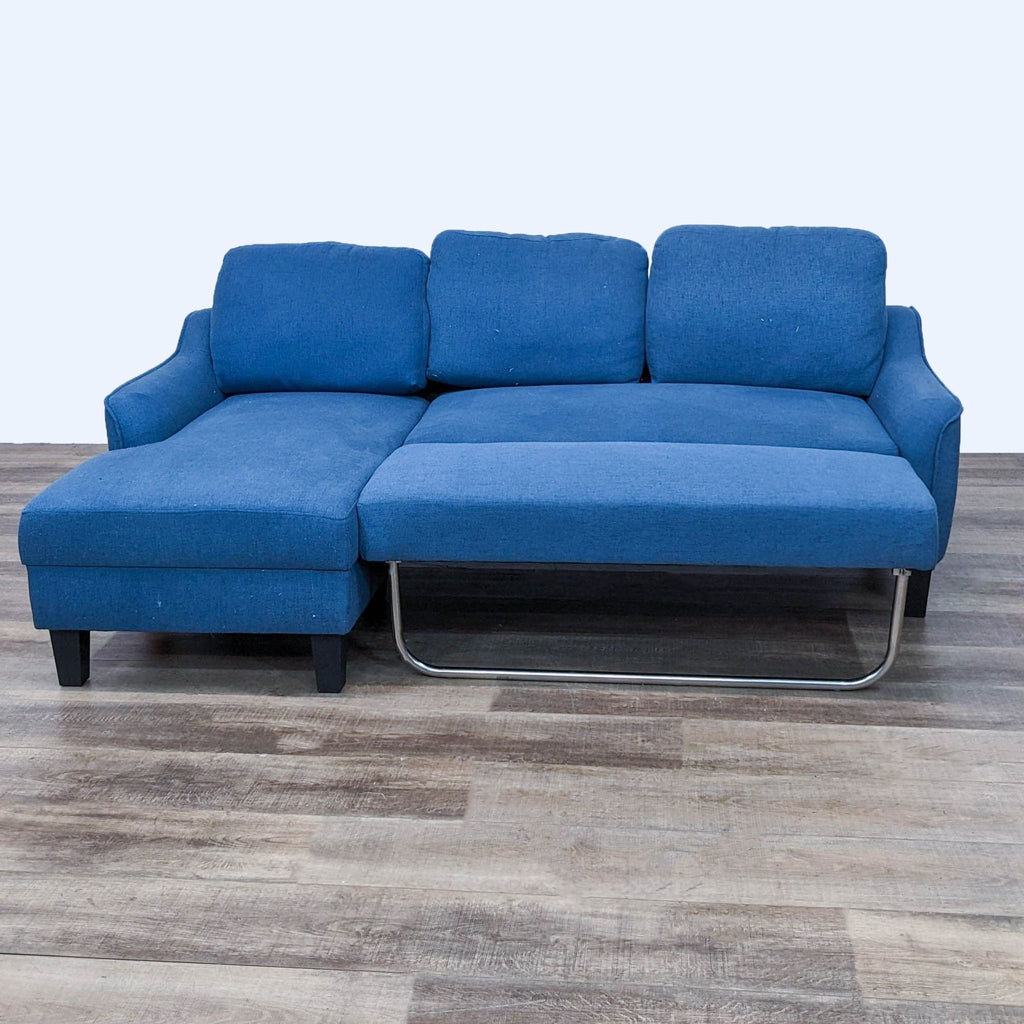 Blue sectional with pull-out sleeper feature and dark finish wood legs.