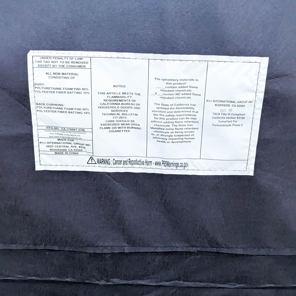 Label details of a sofa, showing materials and safety information on a dark fabric.