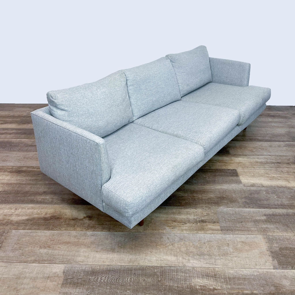 3. Sleek light gray Article 3-seat sofa with narrow arms and tapered walnut legs, viewed from a side angle.